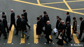 Hong Kong lawyers cross a street as they stage a silent march from the High Court to the Court of Final Appeal in Hong Kong June 27, 2014 (Photo: REUTERS/Bobby Yip)