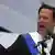 President Juan Carlos Varela delivers a speech as a gust of wind ruffles his hair.