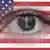 An eye ringed with the NSA symbol peers out from an American flag