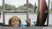 File photo of German Chancellor Angela Merkel entering a 212A class submarine U 33 of the German Navy in the Baltic Sea port of Warnemuende near Rostock August 31, 2006. Merkel will celebrate her 60th birthday on July 17, 2014. REUTERS/Christian Charisius/Files (GERMANY - Tags: POLITICS ANNIVERSARY)