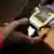Mobilfunk Südafrika - ARCHIV - Ein Mann benutzt am 24.04.2008 in Soweto, Südafrika, ein Mobiltelefon. Soziale Organisationen könnten Internet und Handys laut Experten noch deutlich stärker für ihre Ziele nutzen. EPA/JON HRUSA TO ACCOMPANY DPA STORY BY CHRISTIAN SCHILLER (zu dpa «Mehr digitales Feedback für Hilfsprojekte» vom 16.10.2013) +++(c) dpa - Bildfunk+++