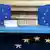 The stars of the EU flag appear on the back rests of two chairs the front of a table (Photo: Foto: Maurizio Brambatti/dpa)