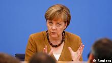 German Chancellor Angela Merkel attends a news conference in Berlin, July 18, 2014. REUTERS/Thomas Peter (GERMANY - Tags: POLITICS)