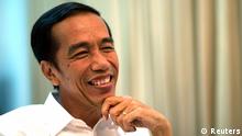 REFILE - UPDATING SLUG AND CAPTION Indonesia's presidential candidate Joko Jokowi Widodo smiles during an interview with Reuters in Jakarta July 19, 2014. Indonesia's new president Jokowi promised to make life simpler for investors by beefing up the country's threadbare infrastructure, untangling near-impenetrable regulations and sacking his ministers if they aren't up to the job. Picture taken July 19, 2014. To match Interview INDONESIA-ELECTION/JOKOWI-INVESTMENT REUTERS/Darren Whiteside (INDONESIA - Tags: POLITICS ELECTIONS BUSINESS)