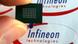 A microchip in front of an Infineon logo A microchip in front of an Infineon logo