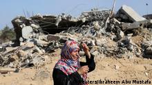 A Palestinian woman reacts upon seeing her house in the east of Khan Younis, which witnesses said was heavily hit by Israeli shelling and air strikes during Israeli offensive, in the southern Gaza Strip August 1, 2014. A Gaza ceasefire crumbled only hours after it began on Friday, with at least 40 Palestinians killed by Israeli shelling and Israel accusing militants of violating the U.S.- and U.N.-brokered truce by firing rockets and mortars. The 72-hour break announced by U.S. Secretary of State John Kerry and U.N. Secretary-General Ban Ki-moon was the most ambitious attempt so far to end more than three weeks of fighting, and followed mounting international alarm over a rising Palestinian civilian death toll. REUTERS/Ibraheem Abu Mustafa (GAZA - Tags: CIVIL UNREST MILITARY POLITICS CONFLICT TPX IMAGES OF THE DAY)
