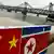 The Chinese and North Korean flags attached to a railing as trucks carrying Chinese-made goods cross into North Korea on the Sino-Korean Friendship Bridge at the Chinese border town of Dandong on December 18, 2013 (Photo: MARK RALSTON/AFP/Getty Images)