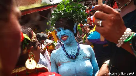 A woman who had painted her face and body blue for the festival.