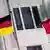 Флаги Германии и Турции на фоне окна за решеткой