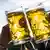 Two Bavarian one liter beer glasses being held up for a toast