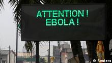A U.N. convoy of soldiers passes a screen displaying a message on Ebola on a street in Abidjan August 14, 2014. The world's worst outbreak of Ebola has claimed the lives of 1,069 people and there are 1,975 probable and suspected cases, the vast majority in Guinea, Liberia and Sierra Leone, according to new figures from the World Health Organisation (WHO). Ivory Coast has recorded no cases of Ebola. REUTERS/Luc Gnago (IVORY COAST - Tags: HEALTH TRANSPORT TPX IMAGES OF THE DAY)