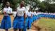 Girls dressed in blue and white school uniforms march in a long line. Photo: Zuberi Mussa Girls dressed in blue and white school uniforms march in a long line. Photo: Zuberi Mussa
