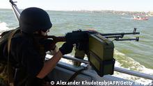 A service man of the maritime security of the State Border Service of Ukraine patrols the sea of Azov off the southern Ukrainian city of Mariupol, on July 31, 2014, to prevent illegal entry of armed groups and smuggling of weapons from nearby Russia. Kiev on July 31 announced a day-long halt to its deadly offensive to oust pro-Russian rebels in east Ukraine after fighting had stalled efforts by international investigators to kickstart a probe into the downing of Malaysia Airlines flight MH17. AFP PHOTO/ ALEXANDER KHUDOTEPLY (Photo credit should read Alexander KHUDOTEPLY/AFP/Getty Images)