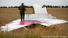 An armed pro-Russian separatist stands on part of the wreckage of the Malaysia Airlines Boeing 777 plane after it crashed near the settlement of Grabovo in the Donetsk region in this July 17, 2014 file photo. The United Nations' civil aviation body will launch two pilot projects designed to help airlines and states better share information about risks in conflict zones, the organization said on August 26, 2014 nearly six weeks after Malaysian airliner flight MH17 was shot down over Ukraine. REUTERS/Maxim Zmeyev/Files (UKRAINE - Tags: TRANSPORT DISASTER CIVIL UNREST)