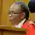 Judge Thokozile Masipa sits before a microphone