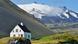 A home in Iceland with a volcano in the background A home in Iceland with a volcano in the background