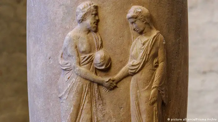 Figures on ancient Greek flask shaking hands