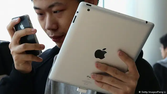 Ein Mann benutzt ein Apple iPad und ein iPhone