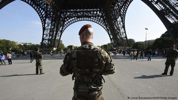 Paratroopers patrol under the Eiffel Tower in Paris, France