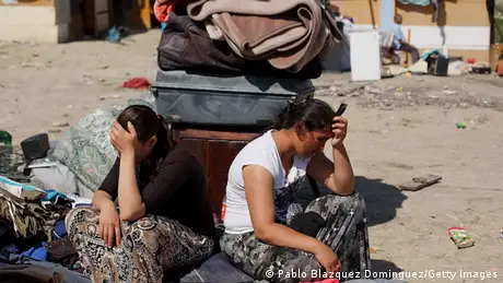 Roma women sit head in hands next to the belongings they could save after their hut was demolished at 'el Gallinero' shanty town on April 9, 2014 in Madrid, Spain. Photo by Pablo Blazquez Dominguez/Getty Images