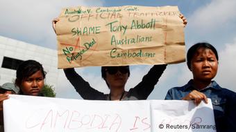 People hold signs during a protest against Cambodia's plans to resettle intercepted refugees, near the Australian embassy in Phnom Penh September 26, 2014 (Photo: REUTERS/Samrang Pring) People hold signs during a protest against Cambodia's plans to resettle intercepted refugees, near the Australian embassy in Phnom Penh September 26, 2014 (Photo: REUTERS/Samrang Pring)