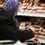Женщина у полок с колбасой в супермаркете