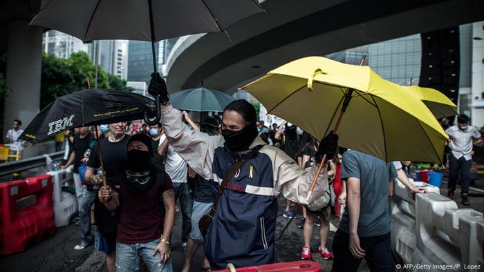 Protests in Hongkong, with people holding umbrellas. 