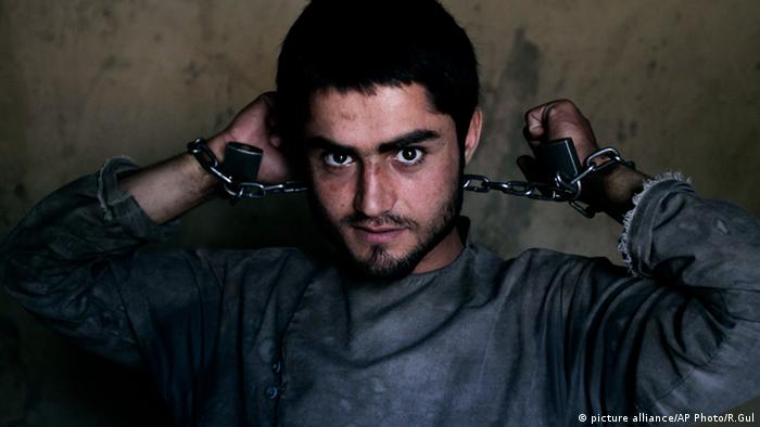 Amanullah, a drug addict, is chained to a wall during his 40-day incarceration at the Mia Ali Baba shrine in Jalalabad, Afghanistan (Photo: AP Photo/Rahmat Gul, File)