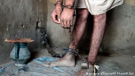A drug addict is chained (Photo: AP Photo/Rahmat Gul)