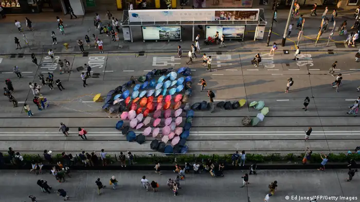 香港市民在铜锣湾用七彩的雨伞拼成了一把大型雨伞