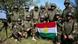 Peshmerga soldiers hold their flag Peshmerga soldiers hold their flag