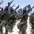 Al-Shabab fighters march with their weapons during military exercises on the outskirts of Mogadishu, Somalia. . (AP Photo/Mohamed Sheikh Nor, File)