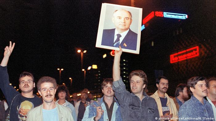 East Germans in 1989 holding up a picture of their new hero, Mikhail Gorbachev