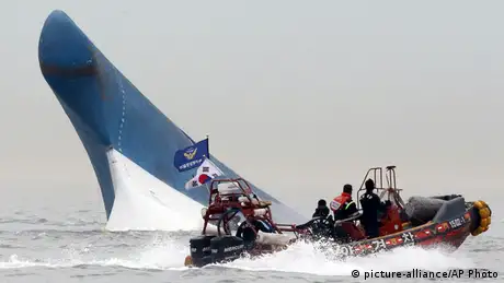 A small motor boat searches for victims of the Sewol accident 