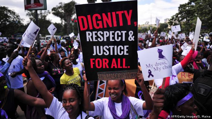 Protesting Kenyan woman holds banner that says dignity, respect and justice for all