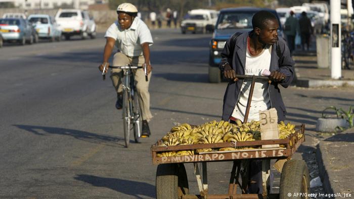 A vendor with a cart of bananas in Zimbabwe