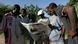 A group of young people on the street in Harare, Zimbabwe reading a newspaper A group of young people on the street in Harare, Zimbabwe reading a newspaper