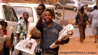 Paper boy in the streets of Rwanda (MARCO LONGARI/AFP).