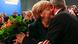 A party fellow congratulates German Chancellor Angela Merkel. (Photo: REUTERS/Kai Pfaffenbach) A party fellow congratulates German Chancellor Angela Merkel. (Photo: REUTERS/Kai Pfaffenbach)