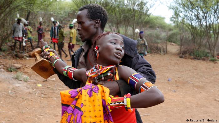 A man taking a young girl off to be married in Baringo County, Kenya, December 7, 2014