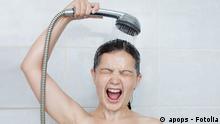 Portrait of a young woman in bathroom screaming in shower Bild: apops - Fotolia