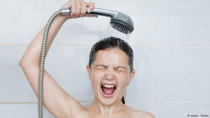 Woman taking a cold shower