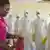 Doctors in white protective suits in Liberia.