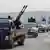Al-Nusra fighters drive in a convoy near Idlib