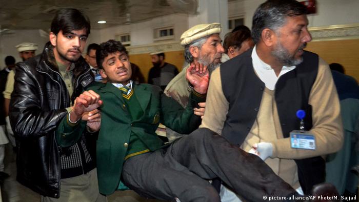 Pakistani volunteers carry a student injured in the shootout at a school under attack by Taliban gunmen, at a local hospital in Peshawar, Pakistan,Tuesday, Dec. 16, 2014 (AP Photo/Mohammad Sajjad)