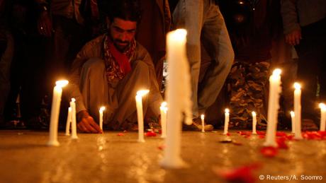 A man lights candles to mourn the victims from the Army Public School in Peshawar, which was attack by Taliban gunmen, in Karachi, December 16, 2014.