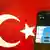 A smartphone and a Turkish flag (Photo: AFP)