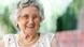 Picture of an old woman wearing glasses and pearls, smiling at the camera. Picture of an old woman wearing glasses and pearls, smiling at the camera.