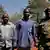Dominic Ongwen with two other men