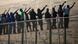 Would-be immigrants stand atop a boarder fence separating Morocco from the north African Spanish enclave of Melilla on May 1, 2014. Would-be immigrants stand atop a boarder fence separating Morocco from the north African Spanish enclave of Melilla on May 1, 2014.